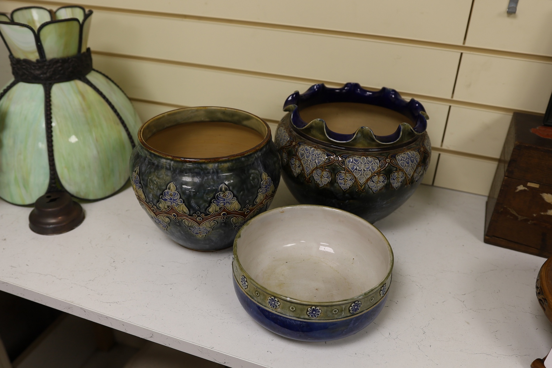 Two Royal Doulton early 20th century stoneware jardinieres and a similar stoneware bowl, tallest jardiniere 22cm high. Condition - frilled edge jardiniere chipped